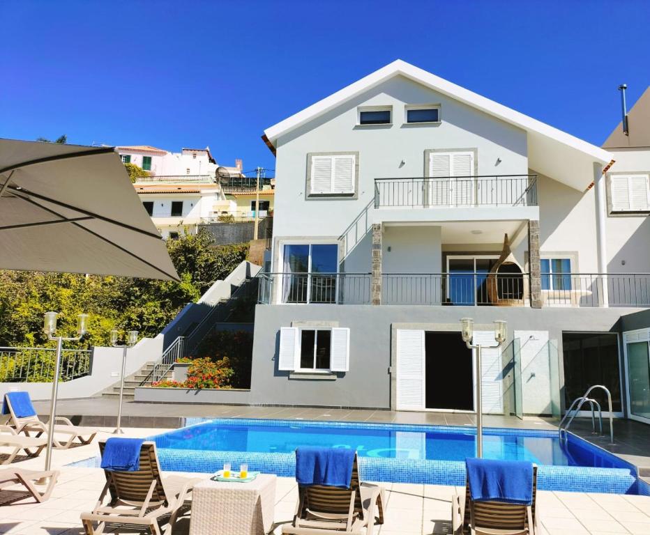 a villa with a swimming pool and a house at Villa Fanny in Ribeira Brava