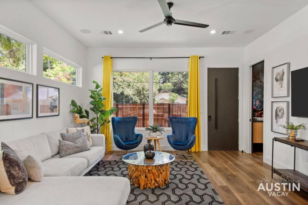 a living room with a white couch and blue chairs at Modern Luxury Home - Minutes from Lady Bird Lake in Austin