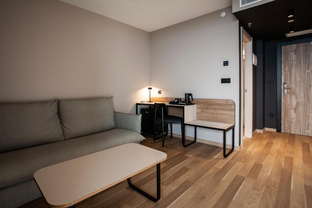 a living room with a couch and a table at Hotel Primavera Park in Benidorm