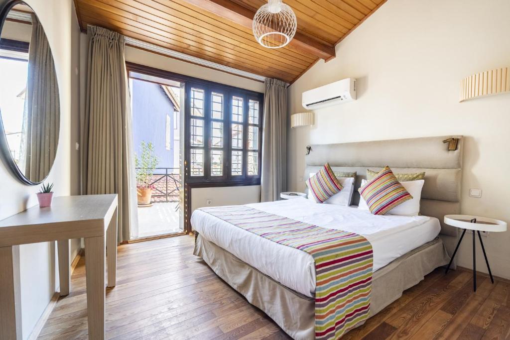 a bedroom with a large bed and a large window at Mesmerizing Flat near Hadrians Gate in Antalya