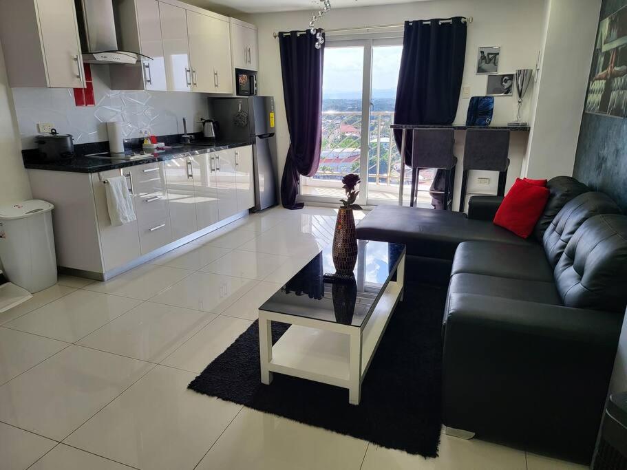 a living room with a couch and a table at Kandi Tower 3, premium 1BR with 2CR & 2 balcony. in Angeles