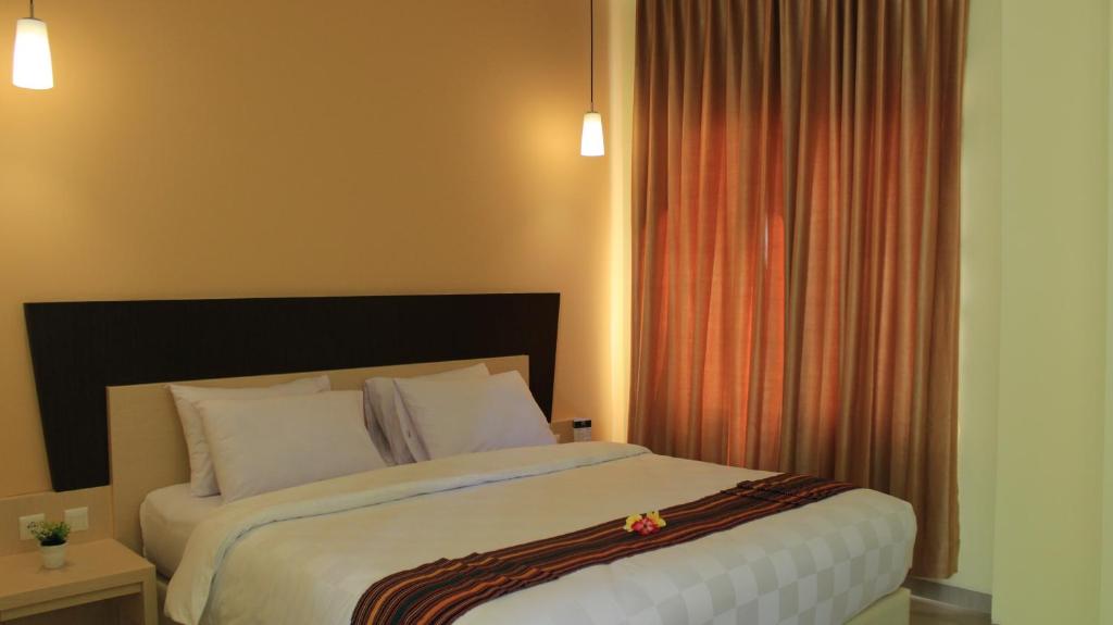 Postel nebo postele na pokoji v ubytování M Hotel