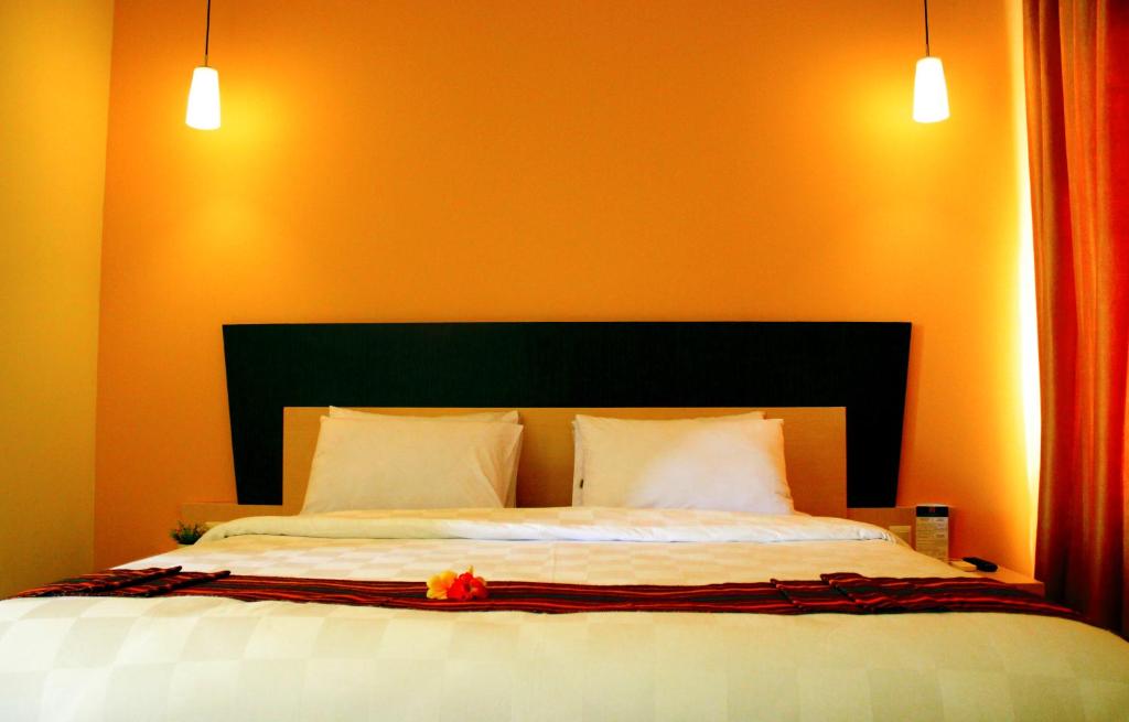 Postel nebo postele na pokoji v ubytování M Hotel