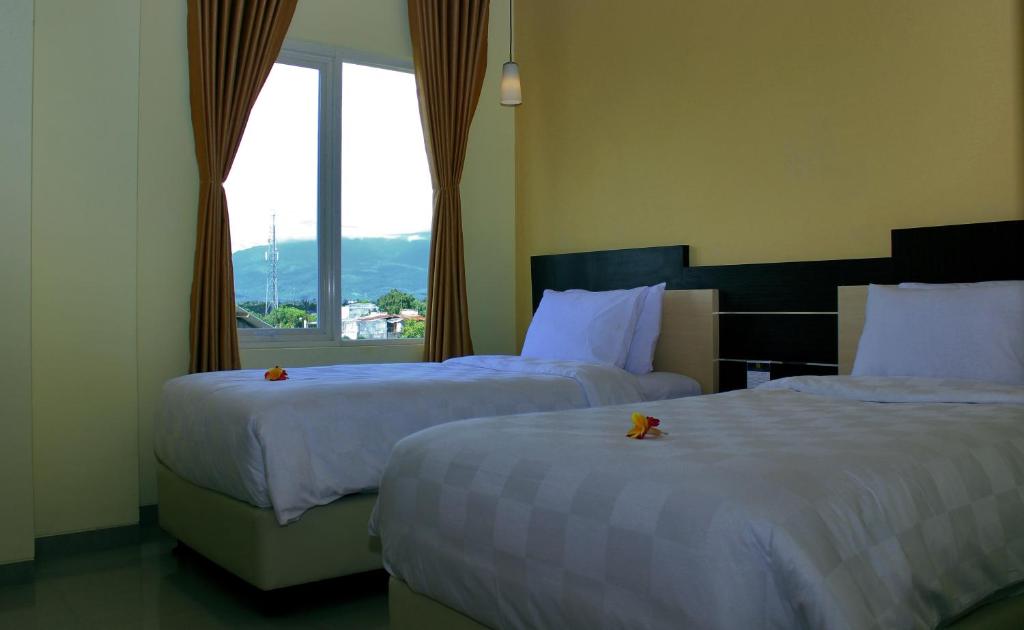 Postel nebo postele na pokoji v ubytování M Hotel