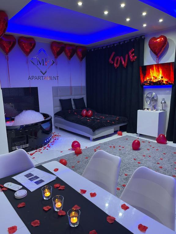 a room with a table and red hearts on the floor at MP Apartament Białystok Jacuzzi in Białystok