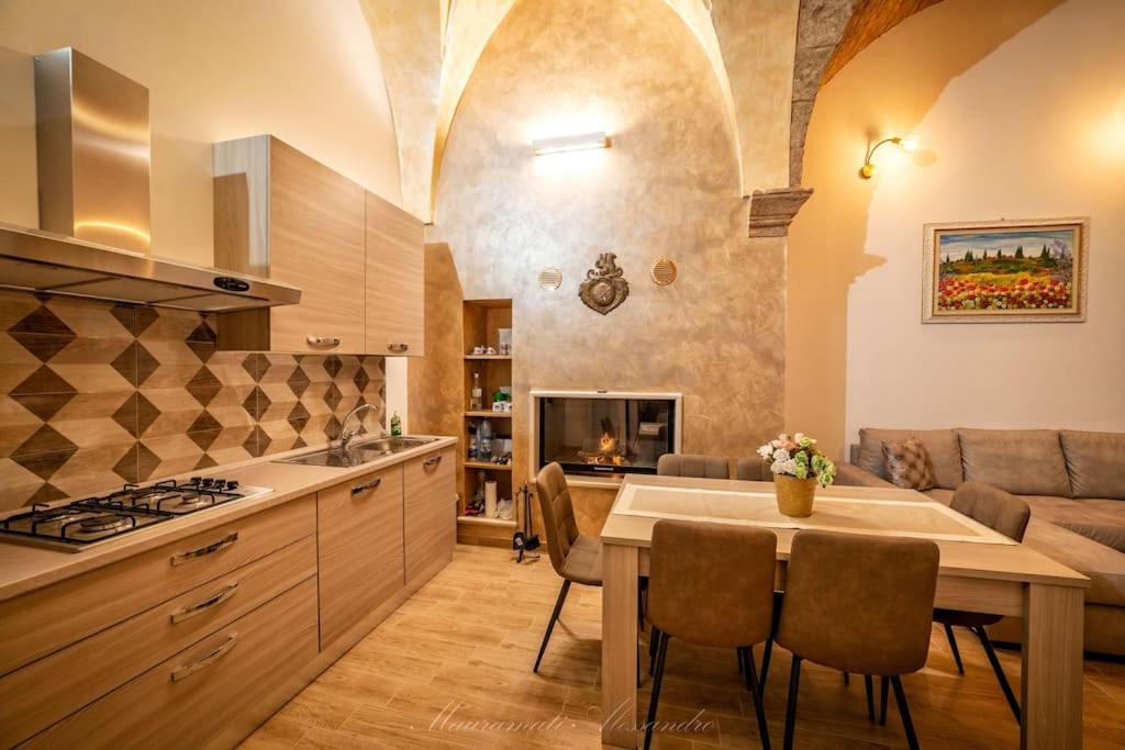 a kitchen and living room with a table and a couch at La Corte GIO' in Taurisano