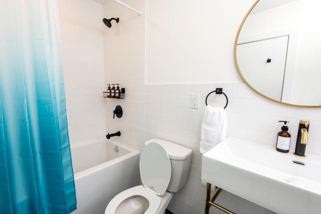 a bathroom with a toilet and a sink and a mirror at The August House in Windsor