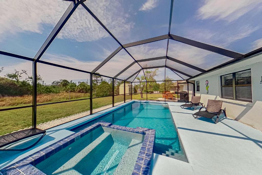 a swimming pool in a house with a glass roof at The Englewood Twin Palms in Englewood