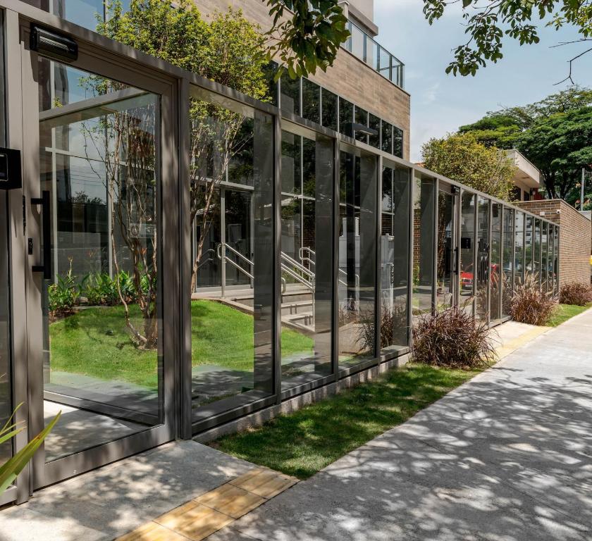 サンパウロにあるApartamentos Studio Allure Moema - Com recepção 24 horasのガラス窓付きの建物の外観