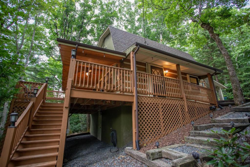 a house in the woods with stairs leading up to it at Have No Regrets in Blowing Rock