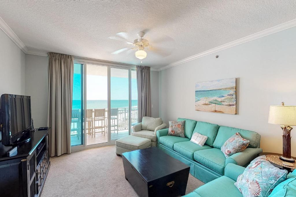 a living room with a couch and a television at Waterscape B603 in Fort Walton Beach
