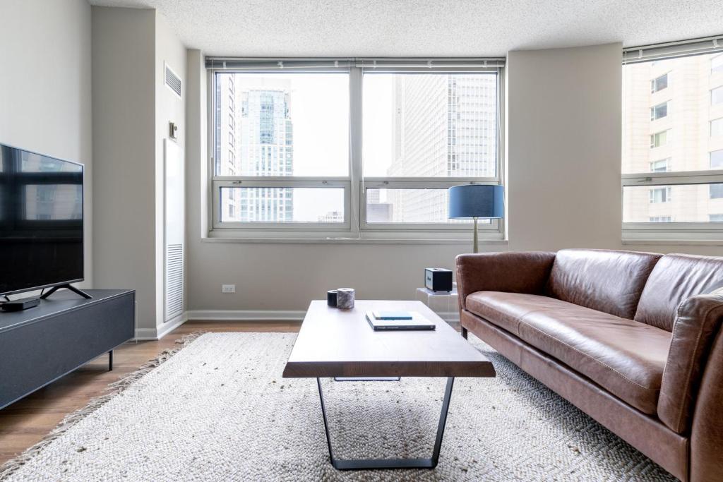 a living room with a couch and a coffee table at River N 2BR wGym Deck Pool nr Mag Mile CHI-133 in Chicago