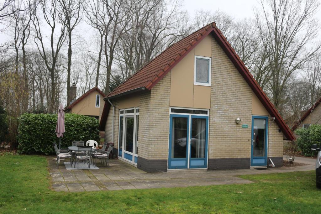 a house with a pitched roof with a patio at ons Bosnest in Dalfsen