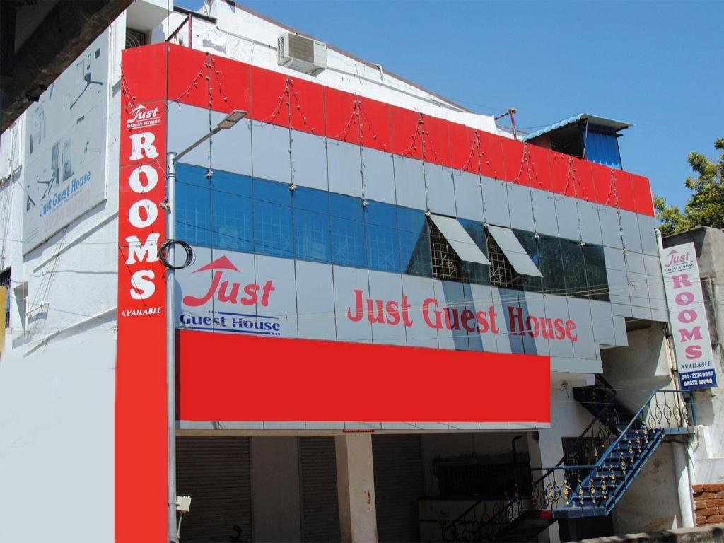 a building with a just guest house sign at Just Guest House, Chennai Airport in Chennai