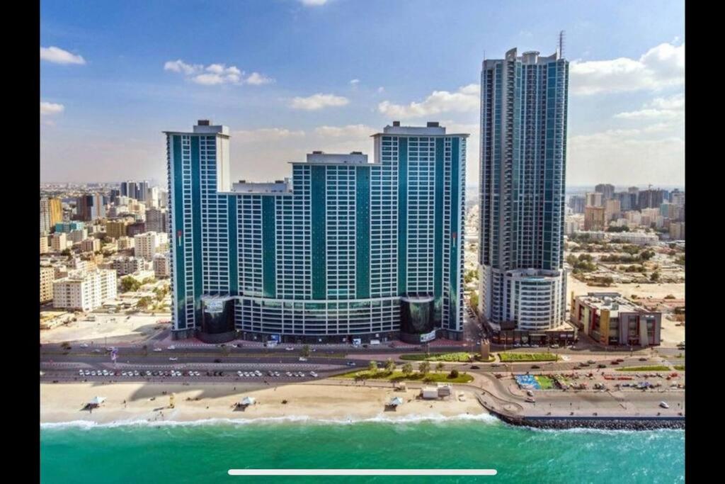 a view of a city with a beach and buildings at stunning 2-bedroom flat in Ajman 
