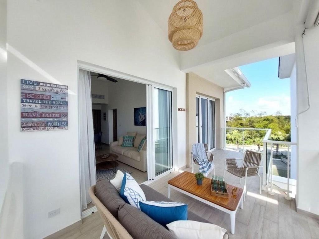 a living room with a couch and a table at Cozy 1BDR with Pool Golf View in Hard Rock Golf in Punta Cana