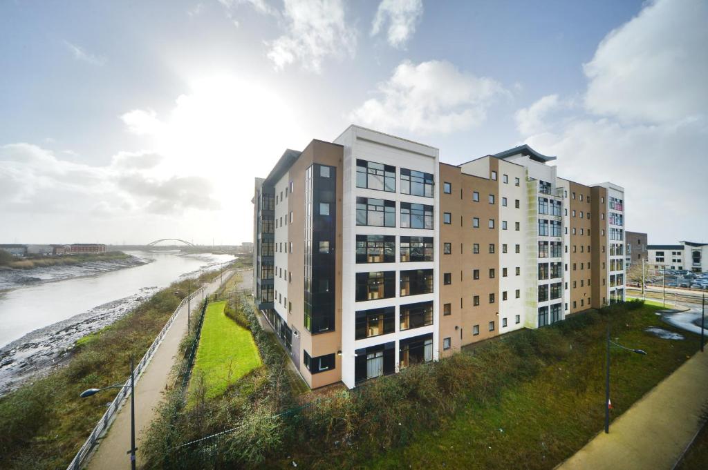 a rendering of a building next to a river at Newport Student Village (Campus Accommodation) in Newport