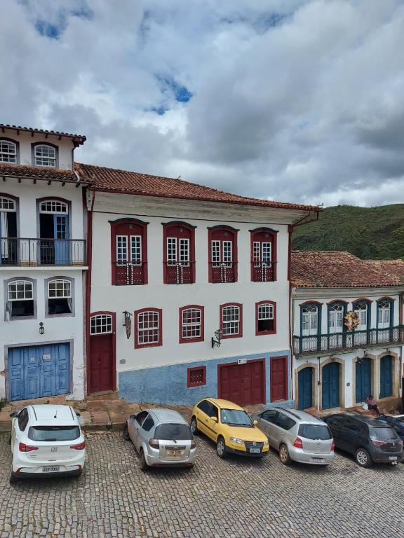 a group of cars parked in a parking lot in front of a building at República Estudantil Birinaite in Ouro Preto