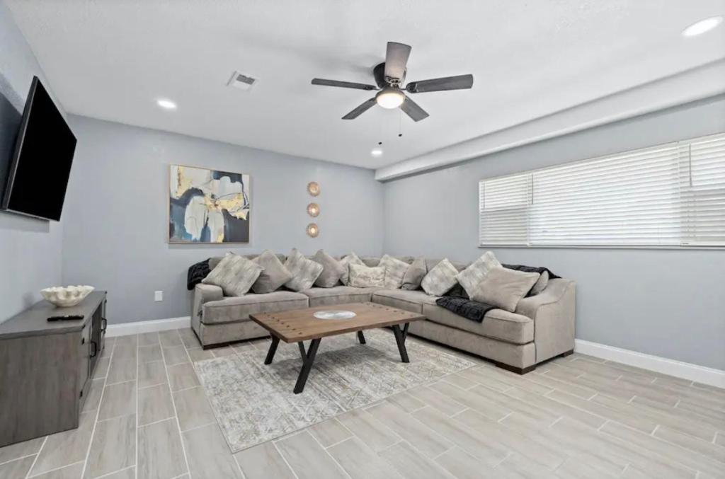 a living room with a couch and a ceiling fan at Clearwater Charm in Clearwater