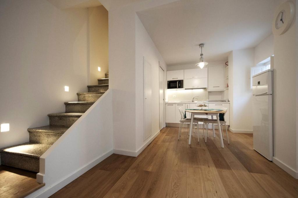 a living room with a staircase and a table at Casa l'Amuri in Modica