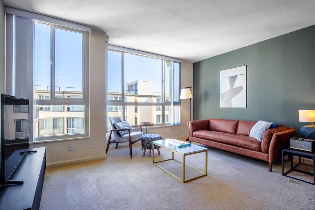 a living room with a couch and a table at N Beach 1BR w Pool Fitness Center nr Muni SFO-233 in San Francisco