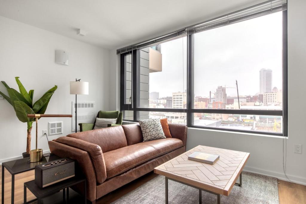 a living room with a couch and a large window at SoMa 1BR w WD Gym Roofdeck nr Muni BART SFO-273 in San Francisco