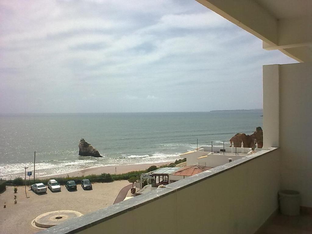 a view of the ocean from the balcony of a building at Rocha Praia Mar Beach Front Line Bay in Portimão