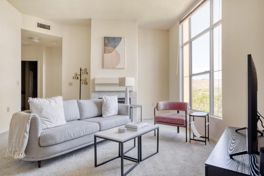 a living room with a couch and a table at Fremont 2BR w Pool WD Gym nr TJ WF SFO-964 in Fremont