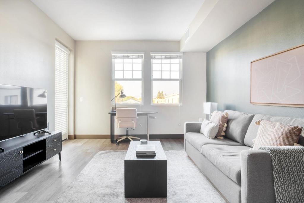 a living room with a couch and a table at Burlingame 1BR w gym wd rooftop nr Caltrain SFO-1056 in Burlingame