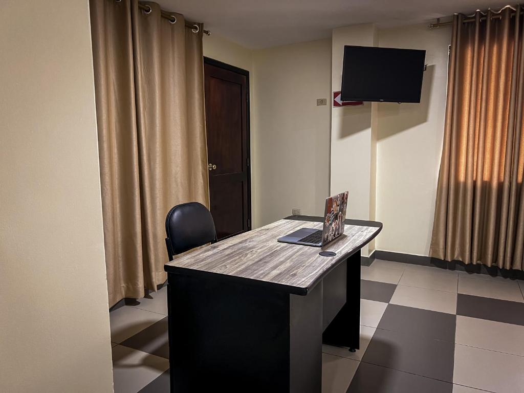 TV a/nebo společenská místnost v ubytování Hostal Wilson Inn
