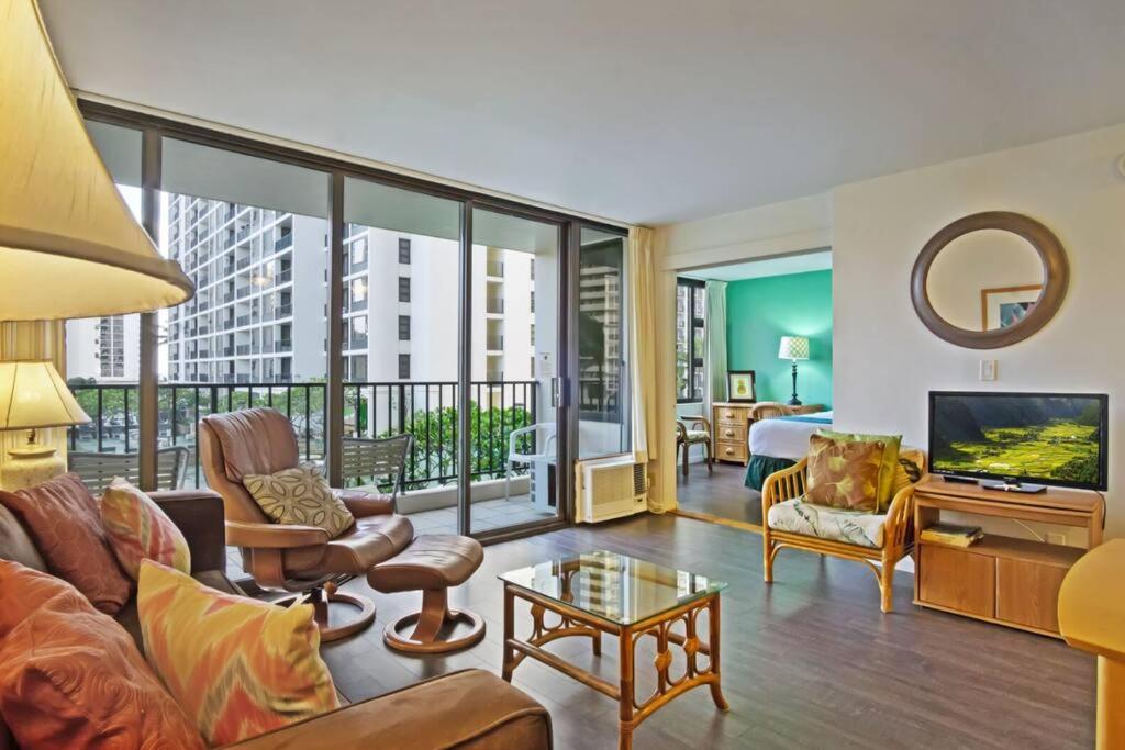 a living room with a couch and a television at Rec Deck Suite, 1 Bed Condo + Free Parking in Honolulu