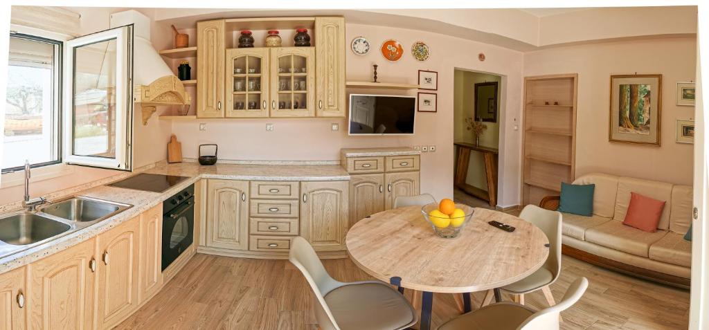 a kitchen with a table and chairs in a room at Seaside Serenity Kefalos in Kefalos