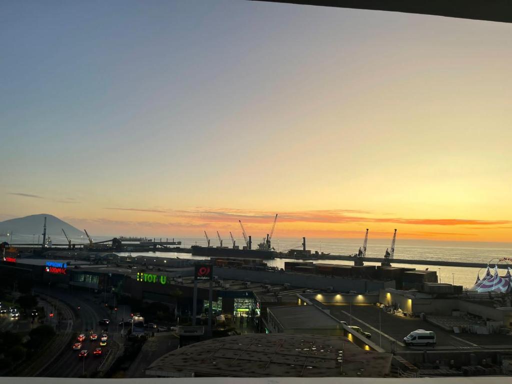 a view of a city with a harbor at sunset at Espectacular vista Antofagasta-SOLO ADULTOS in Antofagasta