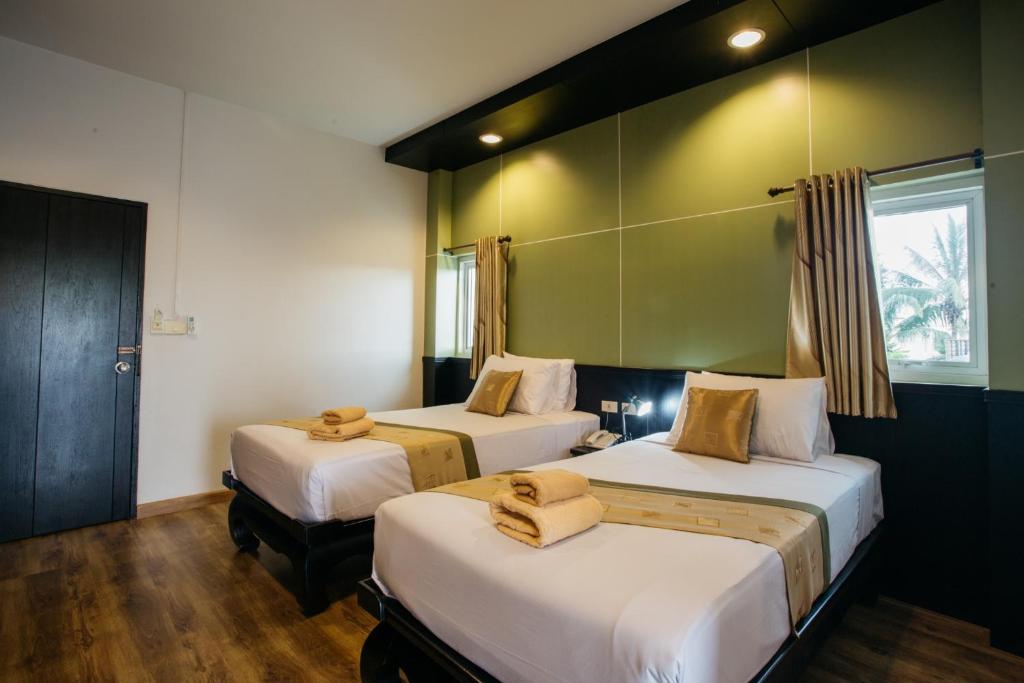 Postel nebo postele na pokoji v ubytování Diamond Park Inn Chiangrai & Resort