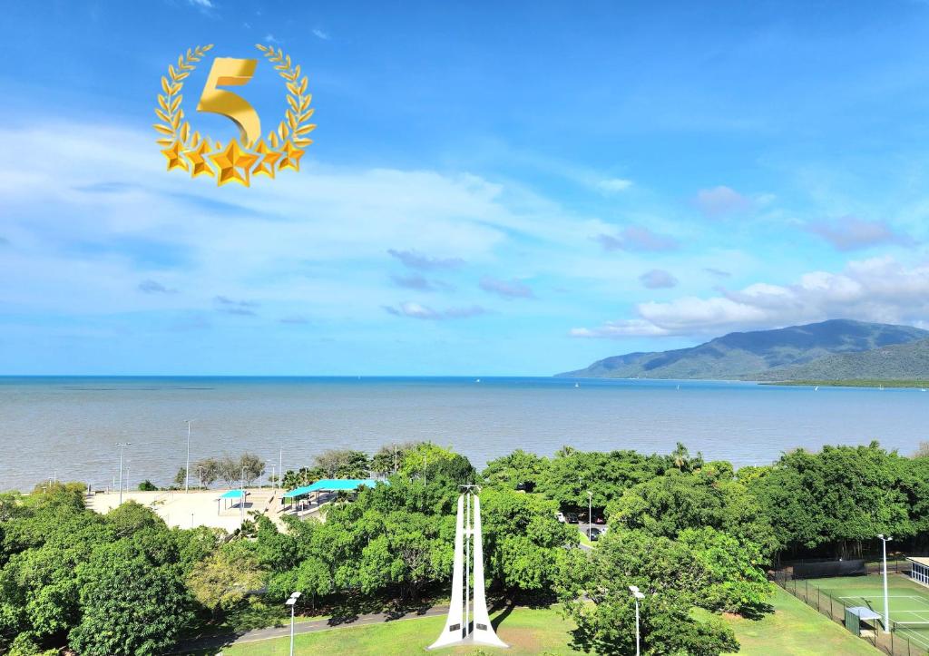 a kite flying in the sky over the water at Cairns Luxury Seaview Apartment in Cairns