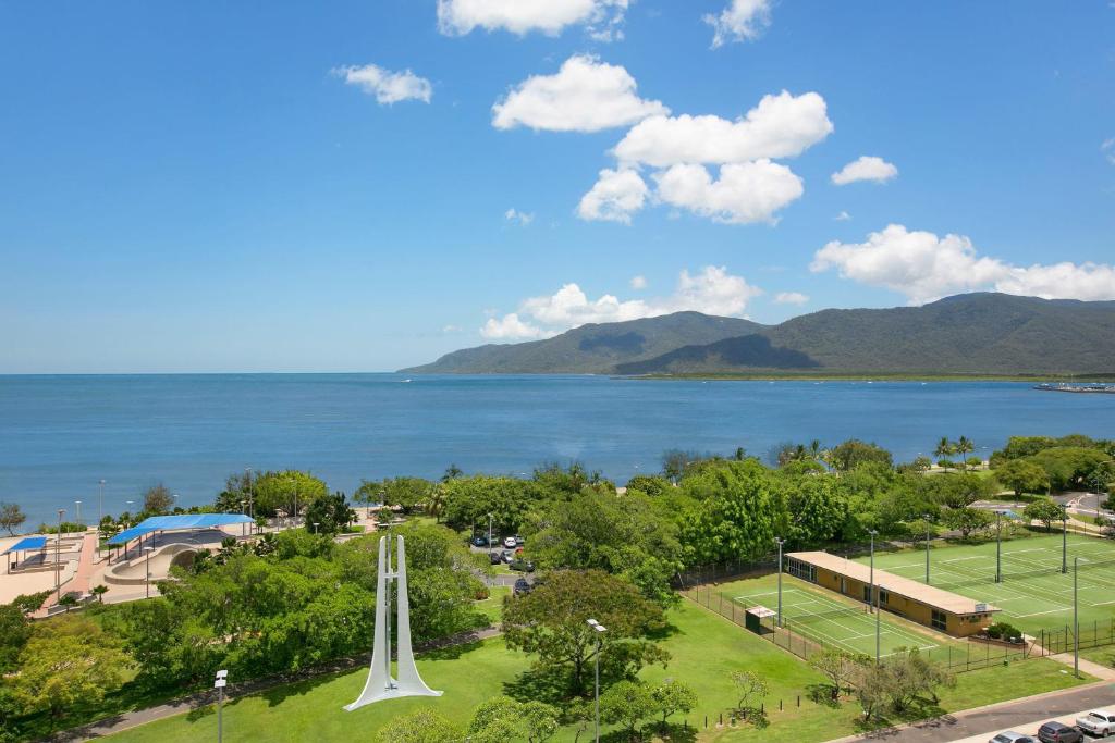 a view of a tennis court and the water at Cairns Ocean View Apartment in Cairns