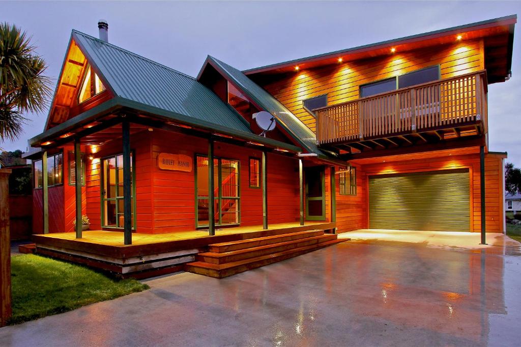 a wooden house with a balcony and a garage at Ridley Manor in Ohakune