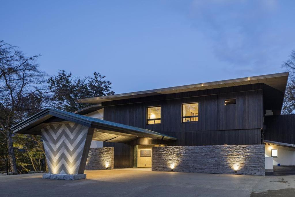 a house with a gambrel roof and a garage at KANAYA RESORT HAKONE in Hakone