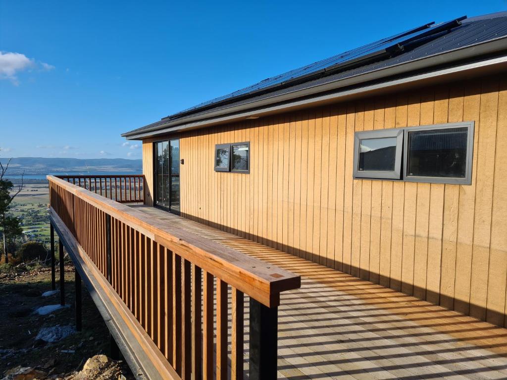 a wooden deck on the side of a house at Mount Rumney Escapes - 3 Seaview Wombat House in Mount Rumney