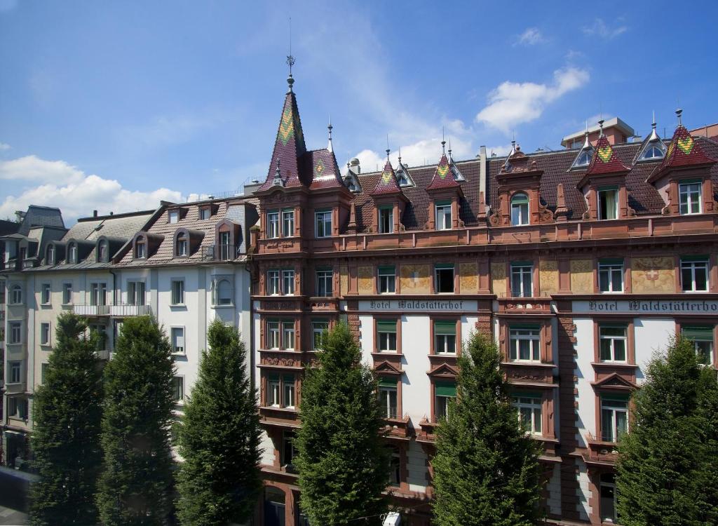 a large building with a tower on top of it at Waldstätterhof Swiss Quality Hotel in Lucerne