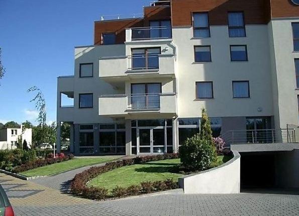 a large white building with a driveway in front of it at Apartamenty Zofia 1 in Władysławowo