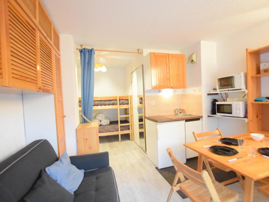 a living room and kitchen with a table and a couch at Studio Bernex, 1 pièce, 4 personnes - FR-1-498-90 in Bernex