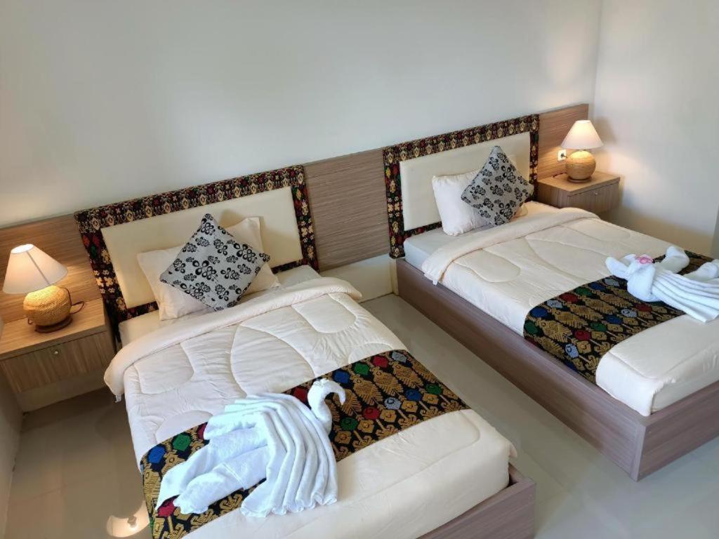 Postel nebo postele na pokoji v ubytování Sapak Bungalow