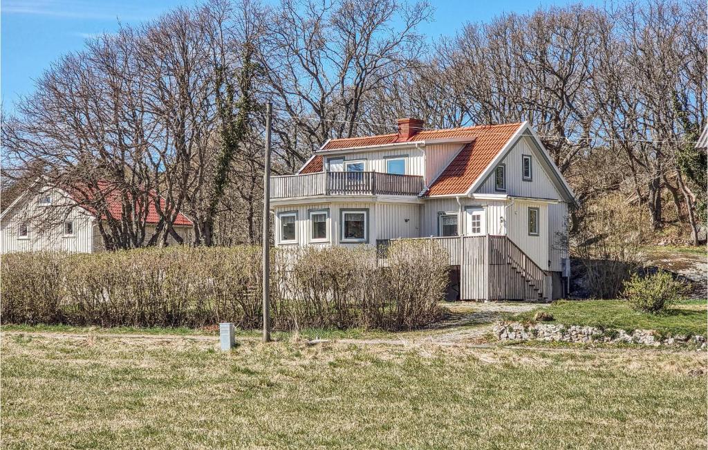 a large white house on top of a hill at Nice Home In Lngekrr With Kitchen in Klövedal