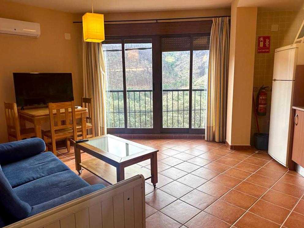 a living room with a couch and a table at El Mirador de Las Hurdes in Ladrillar