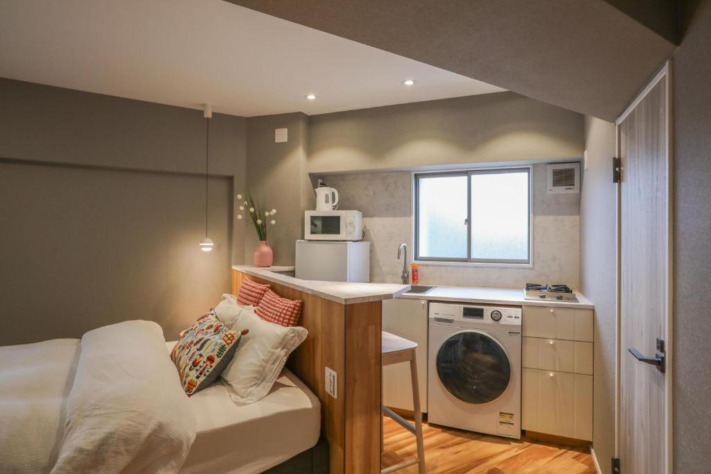 a small room with a bed and a kitchen at ZDT-511 in Tokyo