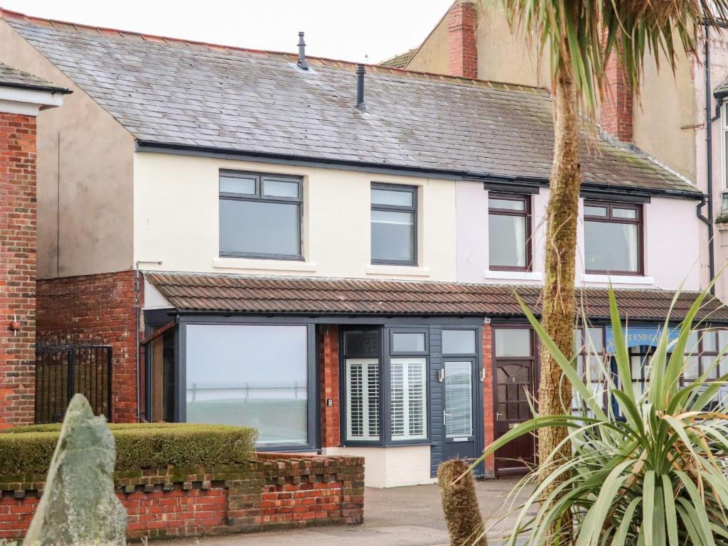 a white house with black windows at Ferry View in Fleetwood