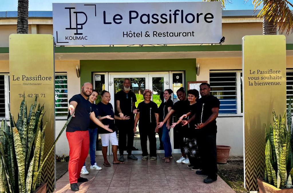 a group of people standing in front of a building at Le Passiflore in Kumak