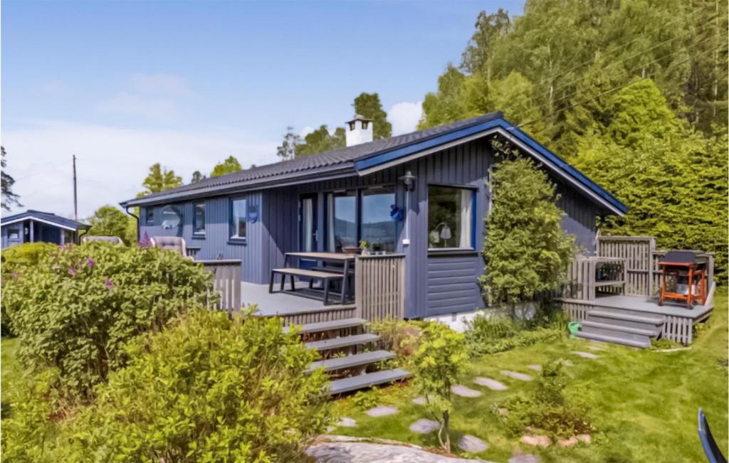 a blue tiny house on a hillside at Stunning Home In Son With 4 Bedrooms in Son