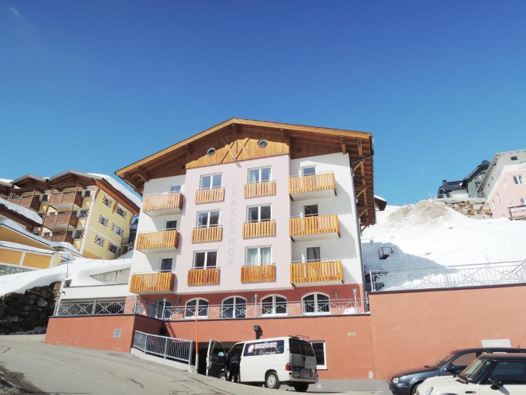a building with cars parked in front of it at Hotel Laaxerhof in Obertauern